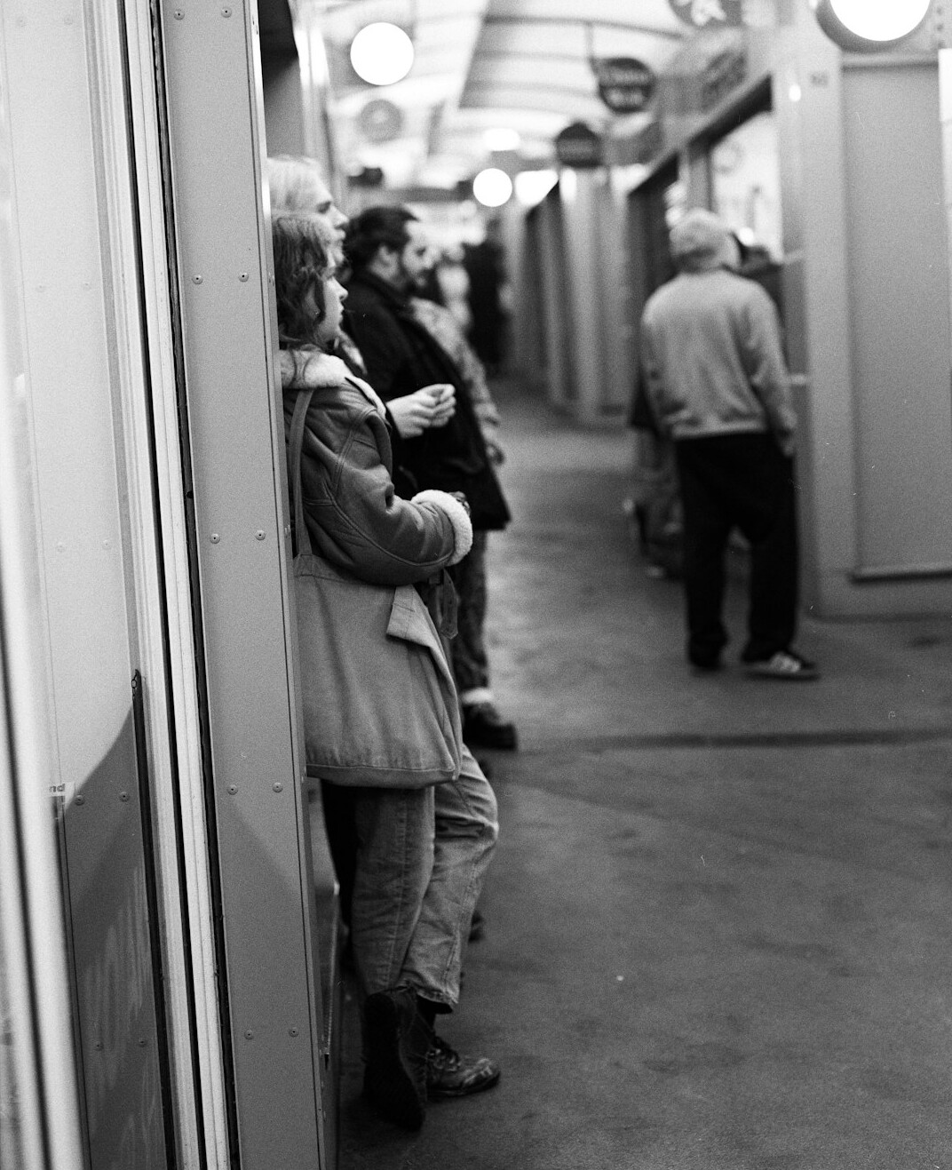 Two people chatting and laughing while standing in a queue