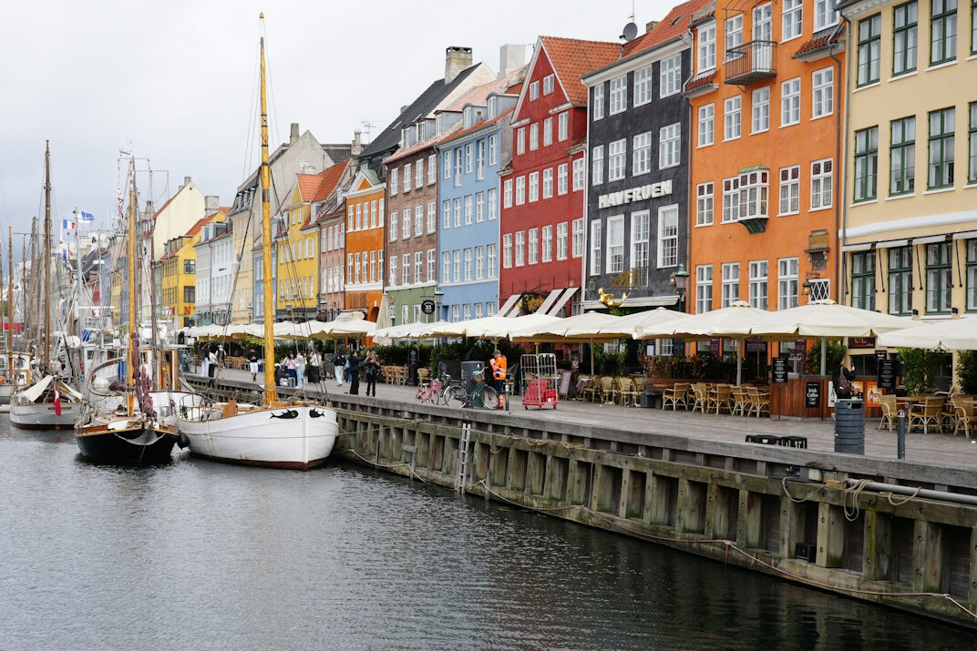 A small market stall with fresh produce at a harbor in Denmark