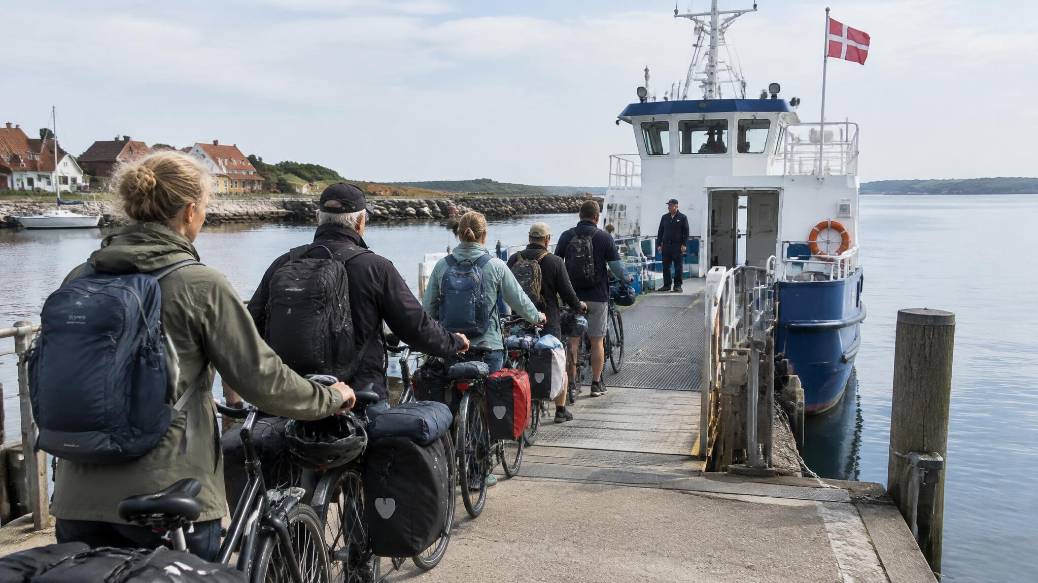 Passengers queueing to board a ferry at a Danish harbor