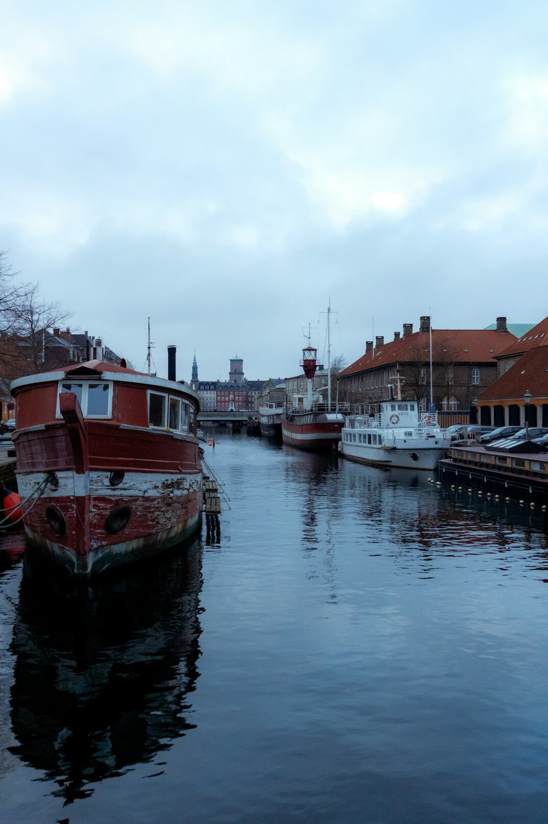 Boats moored along a Danish canal at dusk
