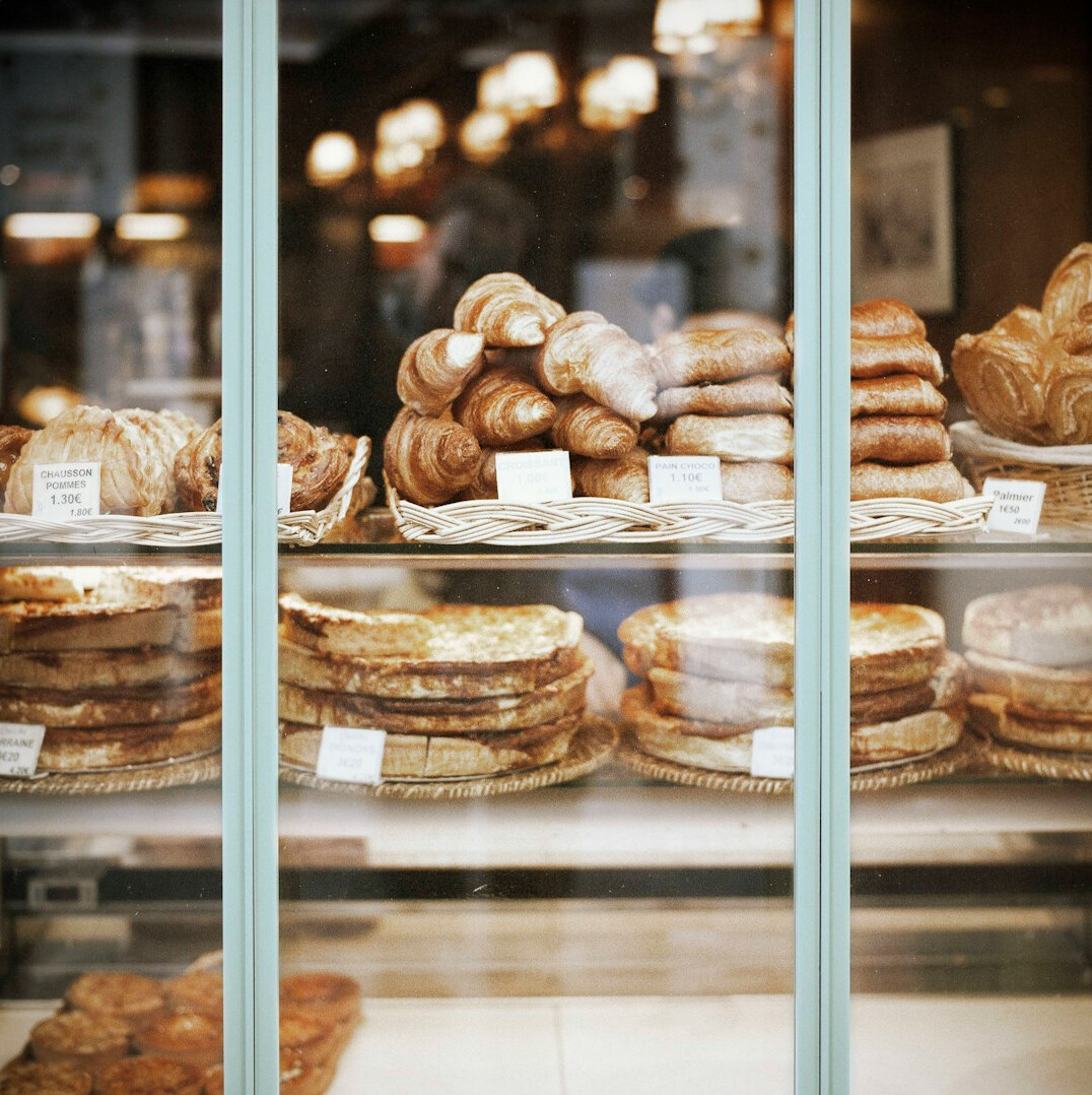 A display of fresh Danish pastries in a bakery window