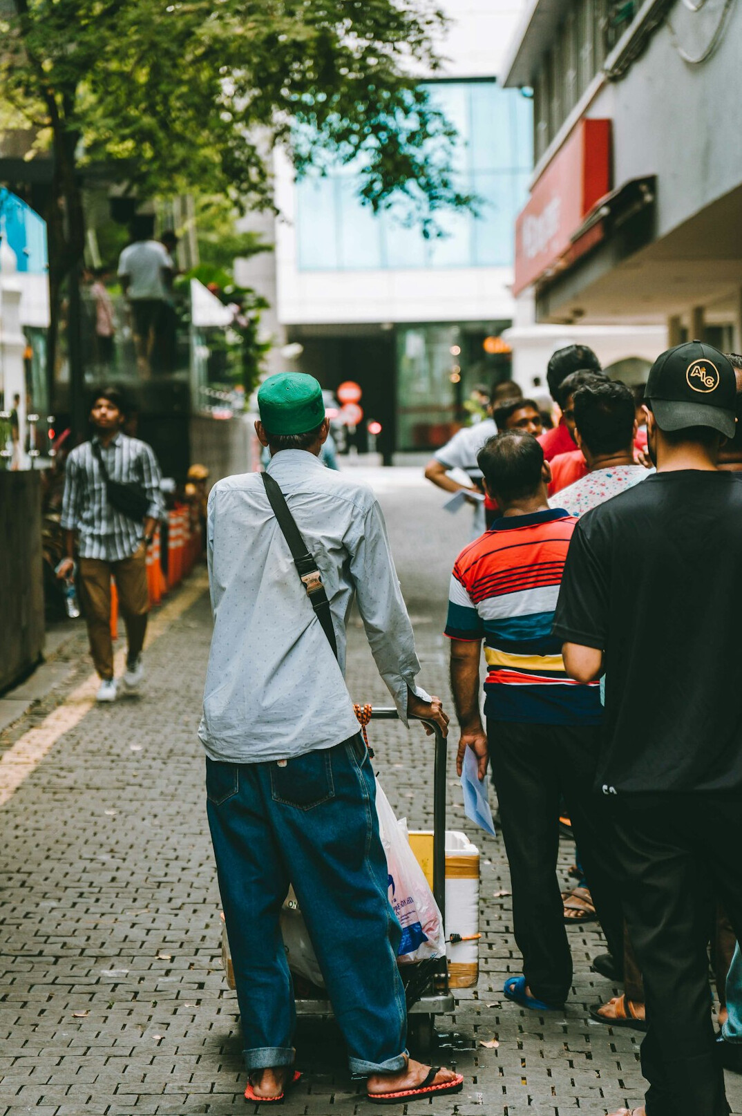 A guide leading a small group of visitors through a city street
