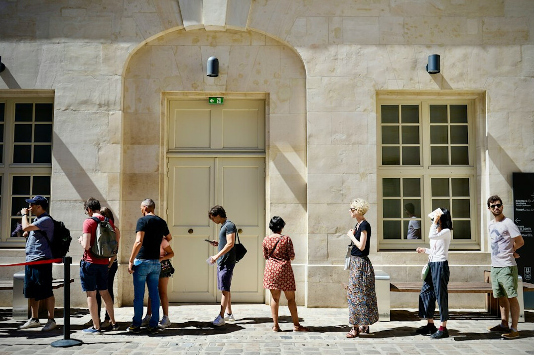 A person waiting at a ticket counter queue in a museum