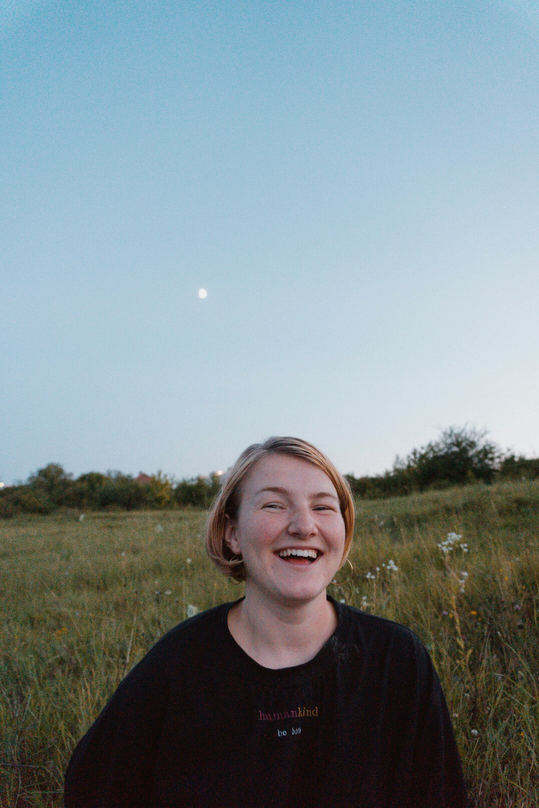 Smiling woman with short blonde hair, co-founder of a storytelling project